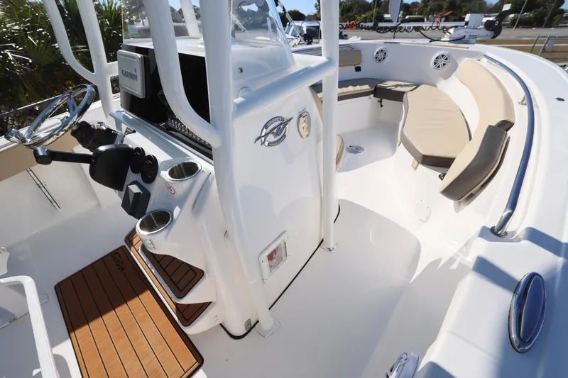 Slide: The Image of 2022 Tidewater 220 CC Adventure boat interior with seating and steering console. - 25
