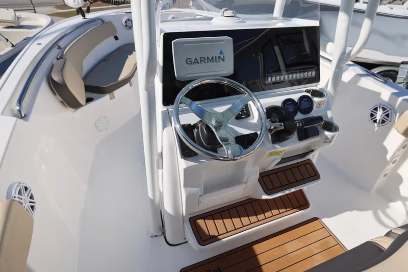 Slide: The Image of 2022 Tidewater 220 CC Adventure boat cockpit with Garmin navigation system and steering wheel. - 26