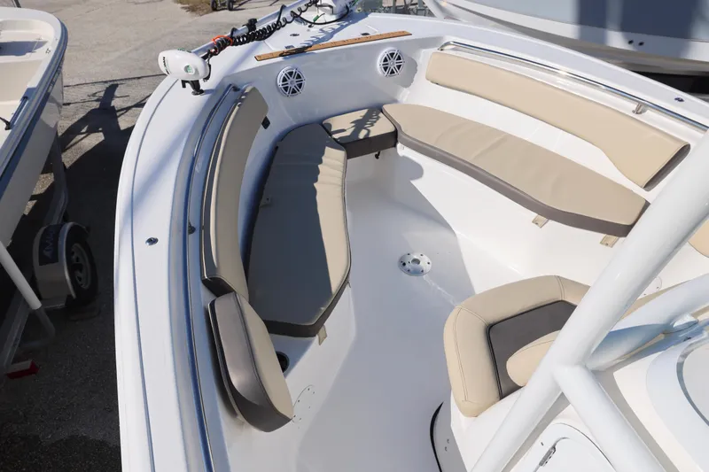 Slide: The Image of 2022 Tidewater 220 CC Adventure boat with beige seating and spacious deck layout. - 27