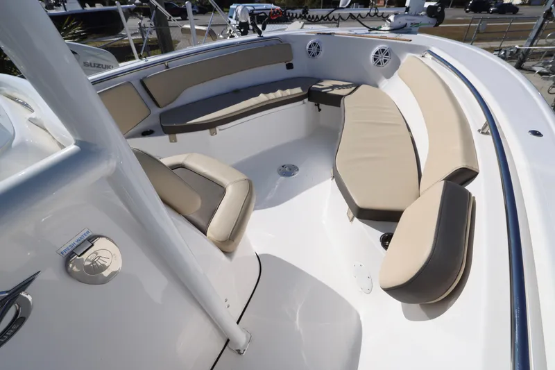 Slide: The Image of 2022 Tidewater 220 CC Adventure boat interior with cushioned seating and modern design. - 5