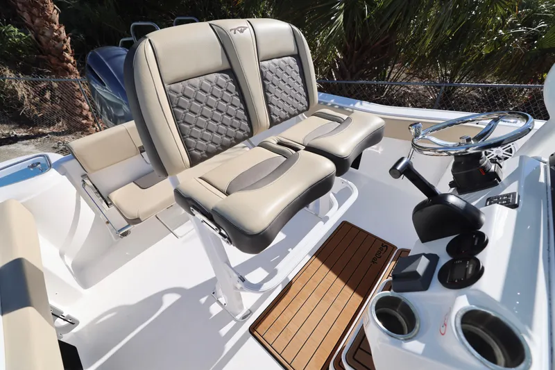 Slide: The Image of 2022 Tidewater 220 CC Adventure boat interior with dual seats and steering console. - 6