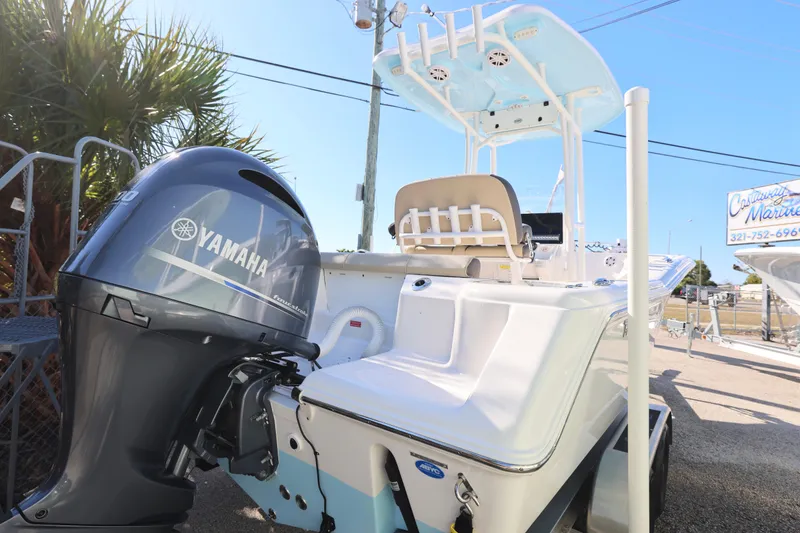 Slide: The Image of 2022 Tidewater 220 CC Adventure boat with Yamaha engine, parked outdoors. - 7