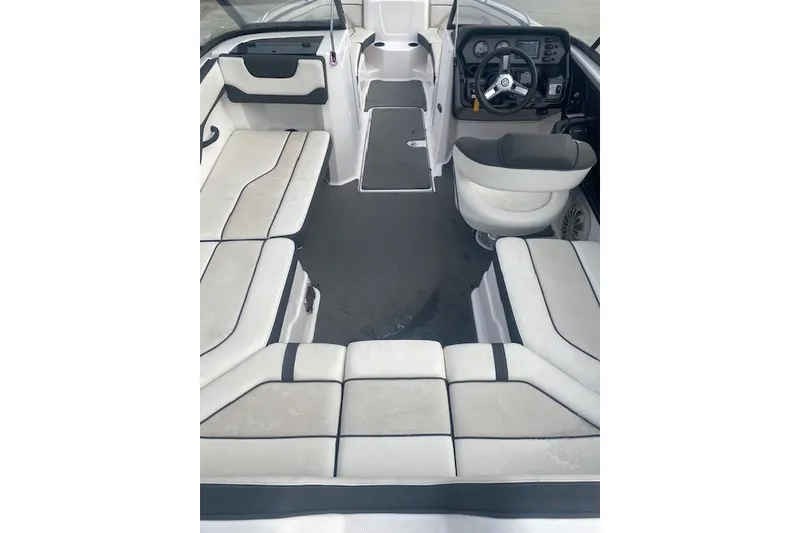 Slide: The Image of 2017 Yamaha Boats AR210 interior with spacious seating and modern dashboard. - 10