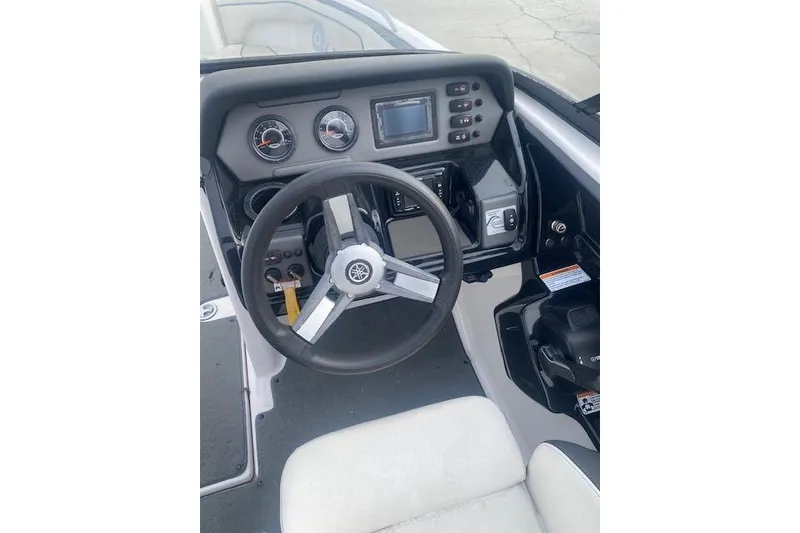 Slide: The Image of 2017 Yamaha Boats AR210 dashboard with steering wheel and control panel. - 11