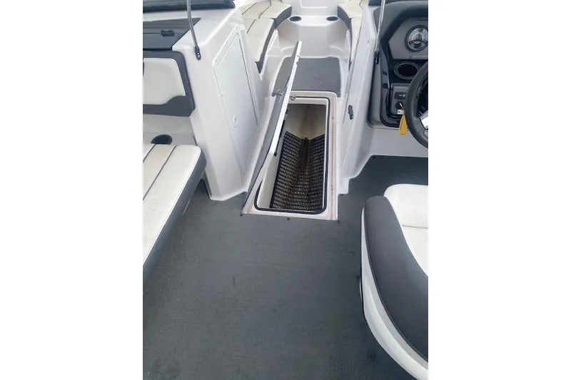 Slide: The Image of 2017 Yamaha AR210 boat interior with open storage compartment and seating. - 14