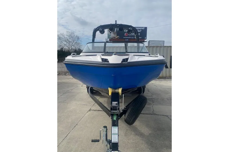 Slide: The Image of 2017 Yamaha Boats AR210 on trailer, blue hull, parked outdoors. - 3