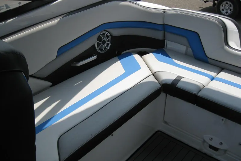 Slide: The Image of 2018 Yamaha Boats 242X E-Series interior seating with blue and white upholstery. - 12