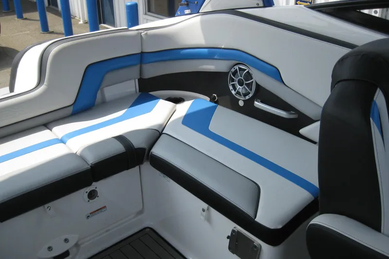 Slide: The Image of 2018 Yamaha Boats 242X E-Series interior with blue and white seating and speaker system. - 13