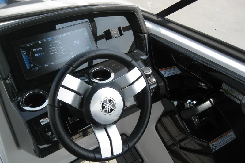 Slide: The Image of 2018 Yamaha Boats 242X E-Series dashboard with steering wheel and digital display. - 17