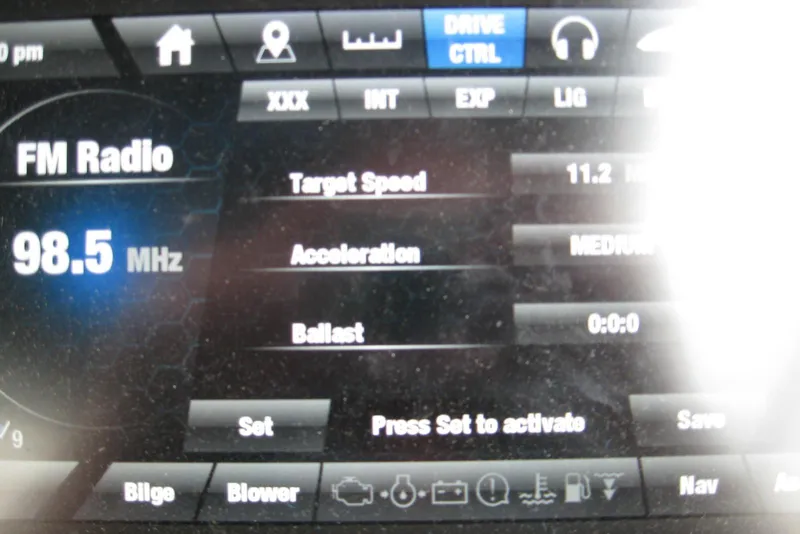 Slide: The Image of Dashboard display of 2018 Yamaha Boats 242X E-Series showing FM radio and speed settings. - 20