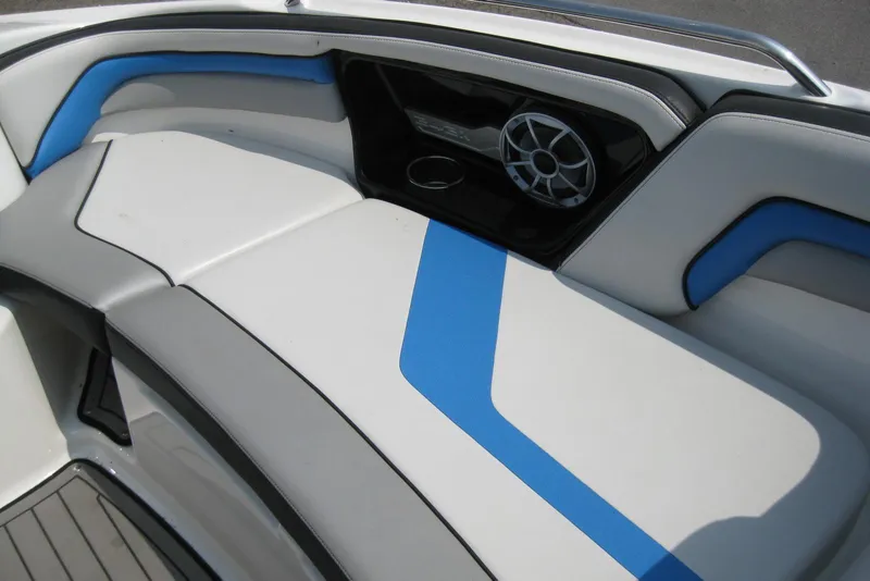 Slide: The Image of 2018 Yamaha Boats 242X E-Series interior with blue and white seating and speaker system. - 28