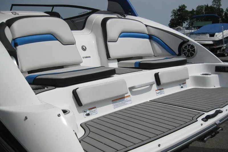 Slide: The Image of 2018 Yamaha Boats 242X E-Series interior with cushioned seating and sleek design. - 8