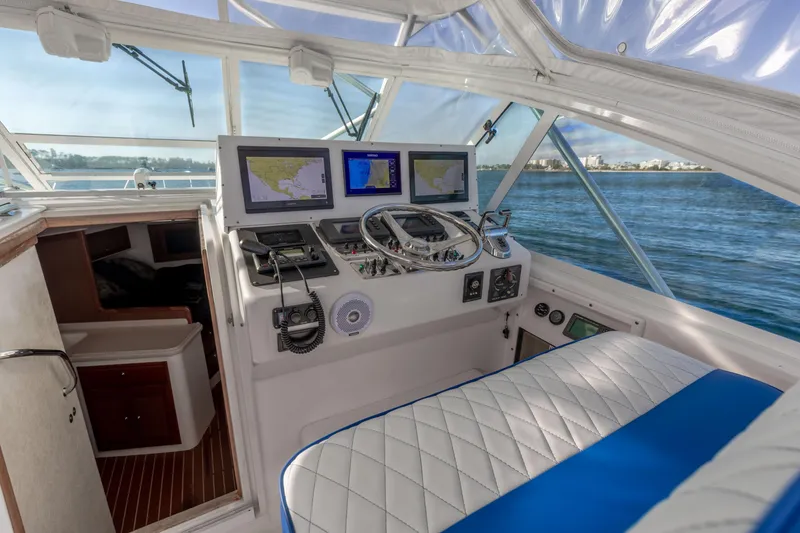 Slide: The Image of Interior of 2000 Cabo 35 Express boat with navigation equipment and seating. - 17