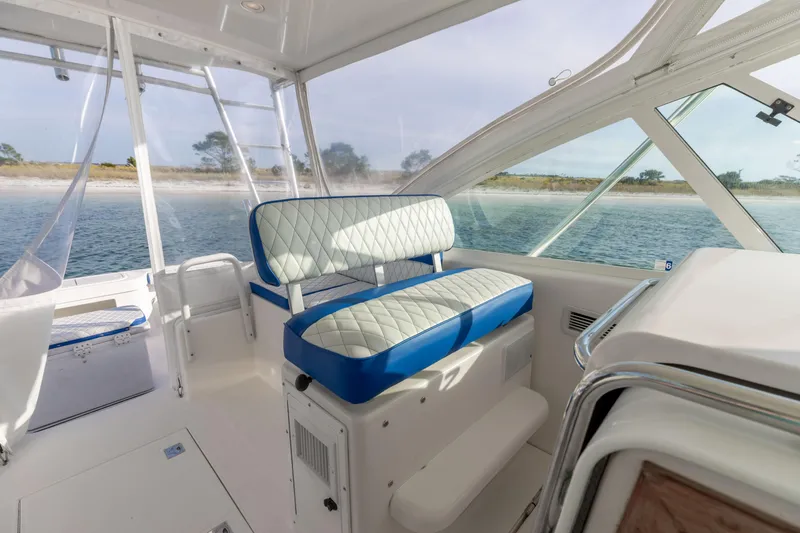 Slide: The Image of Interior of 2000 Cabo 35 Express boat with blue and white seating, ocean view. - 19