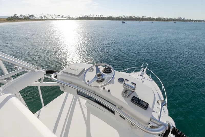 Slide: The Image of Helm of 2000 Cabo 35 Express yacht overlooking serene ocean waters. - 29