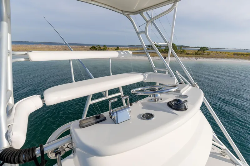 Slide: The Image of Helm of 2000 Cabo 35 Express yacht overlooking serene coastal waters. - 30