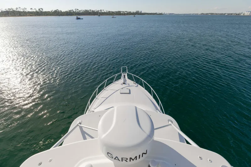 Slide: The Image of Bow view of 2000 Cabo 35 Express yacht on calm waters. - 33