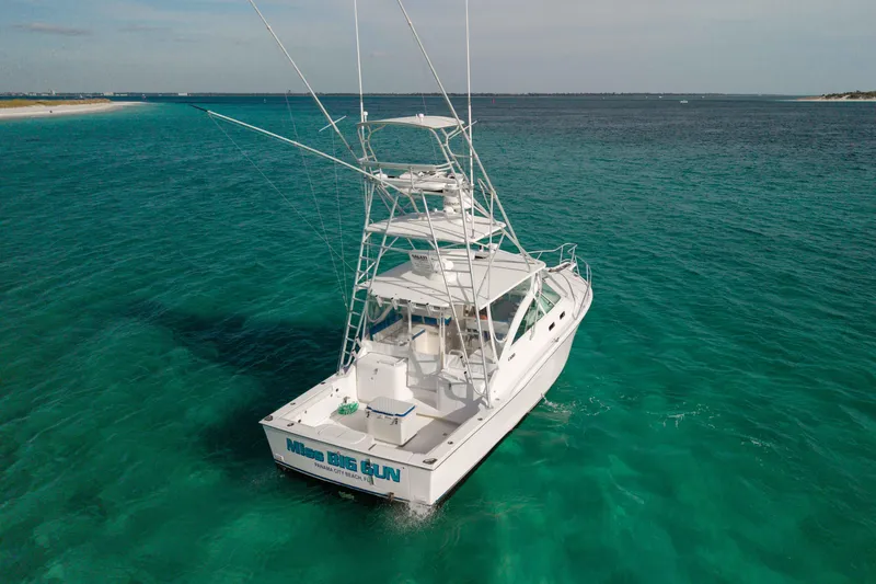 Slide: The Image of 2000 Cabo 35 Express boat on clear turquoise water, rear view. - 39