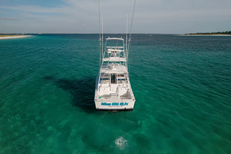 Slide: The Image of 2000 Cabo 35 Express boat on clear turquoise water, viewed from the rear. - 40