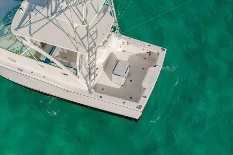 Slide: The Image of 2000 Cabo 35 Express boat on turquoise water, aerial view. - 42