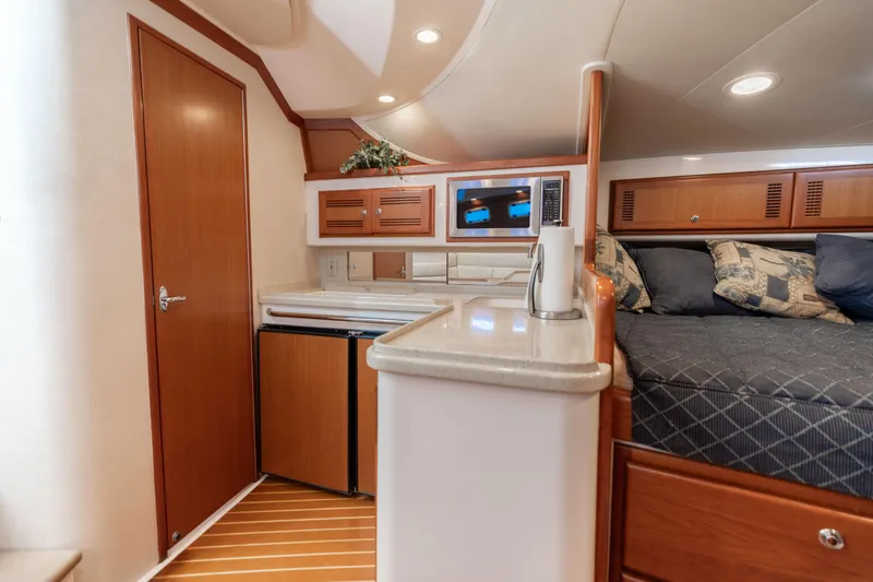 Slide: The Image of Interior of 2000 Cabo 35 Express yacht with kitchenette and cozy sleeping area. - 6