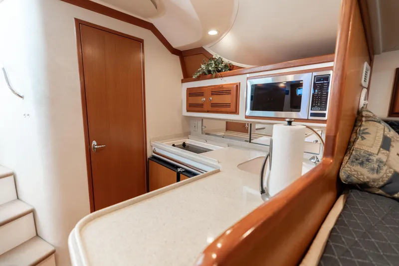 Slide: The Image of Interior of 2000 Cabo 35 Express yacht featuring a modern kitchen area. - 7