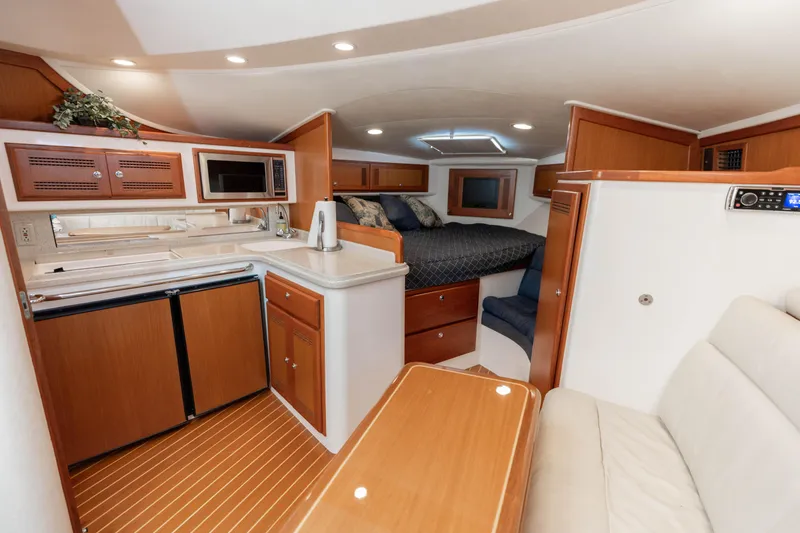 Slide: The Image of Interior of 2000 Cabo 35 Express yacht with kitchen, seating, and sleeping area. - 9