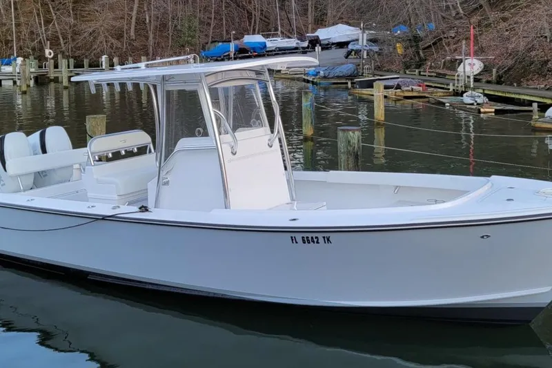 Slide: The Image of 2023 Albury Brothers 27 boat docked in a serene marina setting. - 3