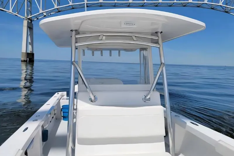 Slide: The Image of 2023 Albury Brothers 27 boat on calm water under a bridge. - 4