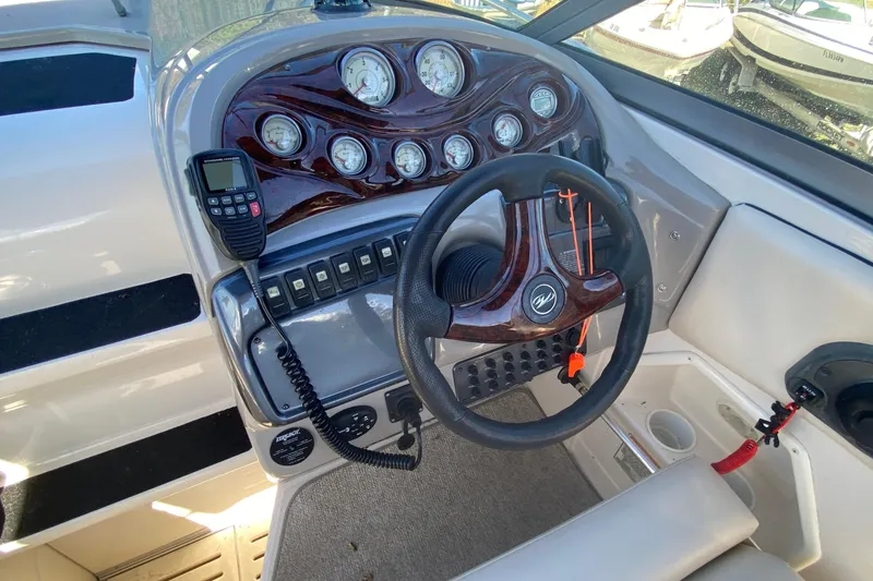 Slide: The Image of 2004 Monterey 245 Cruiser dashboard with steering wheel, gauges, and radio controls. - 10