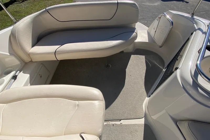 Slide: The Image of 2004 Monterey 245 Cruiser interior with beige seating and carpeted floor. - 12