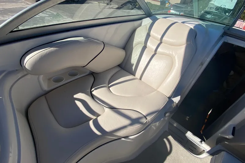 Slide: The Image of 2004 Monterey 245 Cruiser interior with beige leather seating and cup holders. - 14