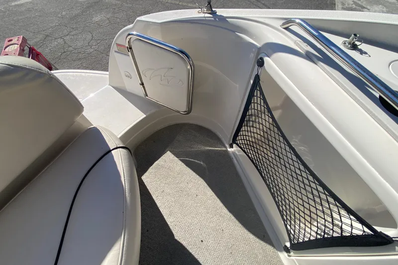 Slide: The Image of Interior view of a 2004 Monterey 245 Cruiser boat with seating and storage net. - 16