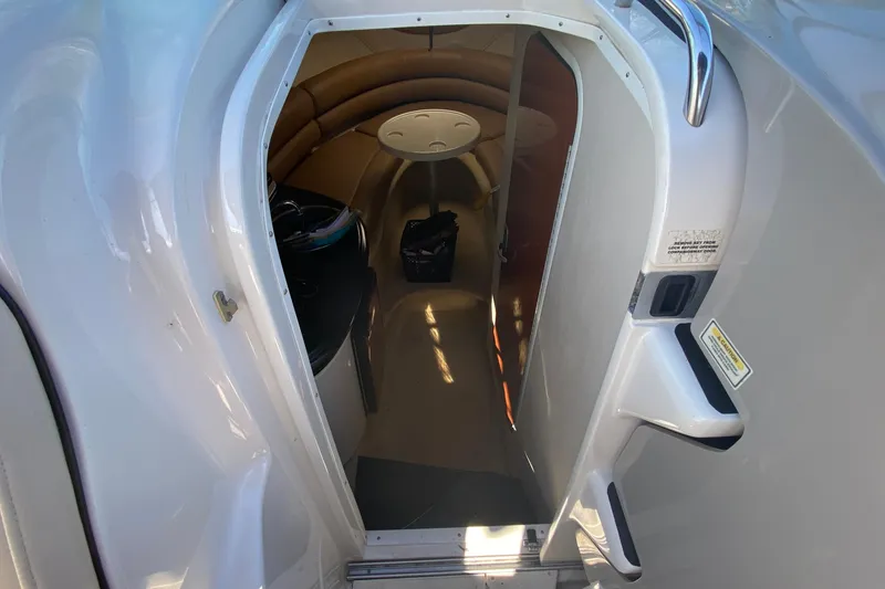 Slide: The Image of 2004 Monterey 245 Cruiser cabin interior with seating and table, viewed from entrance. - 17