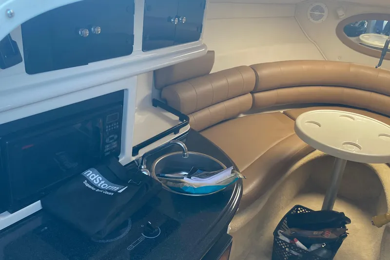 Slide: The Image of Interior of 2004 Monterey 245 Cruiser with kitchenette and curved seating area. - 18