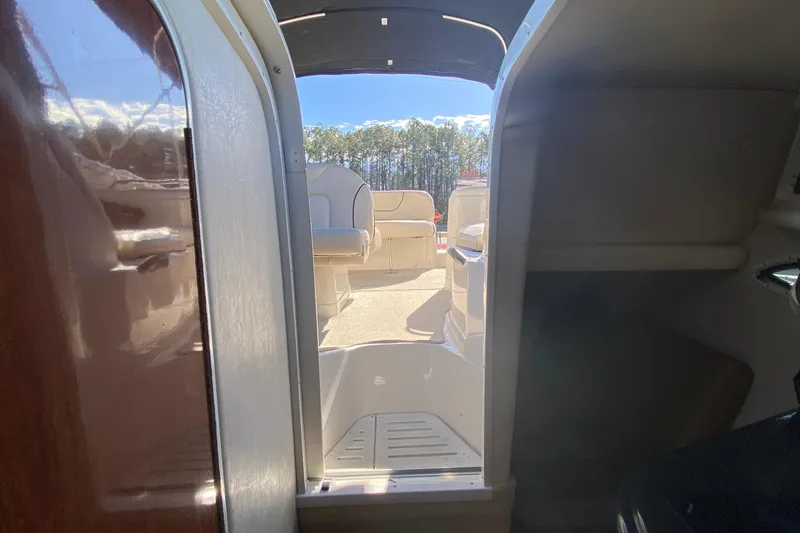 Slide: The Image of Interior view of 2004 Monterey 245 Cruiser boat, showing cabin entrance and seating area. - 25