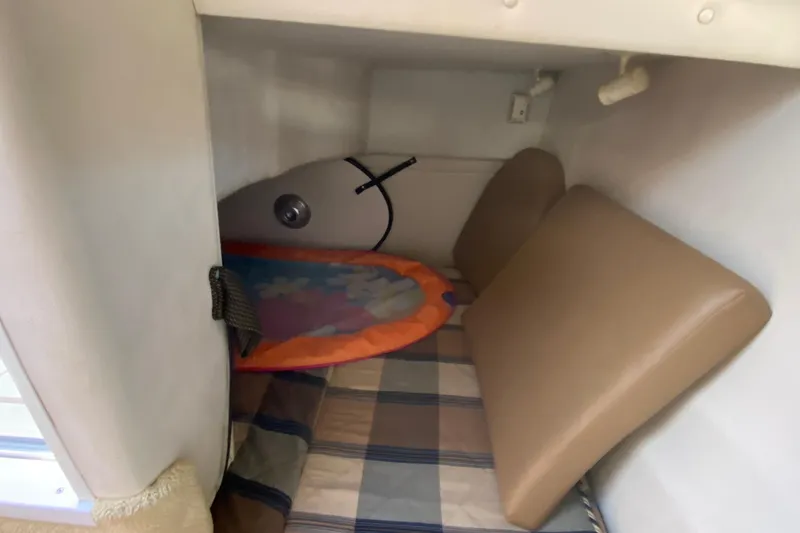 Slide: The Image of 2004 Monterey 245 Cruiser cabin interior with cushions and colorful mat. - 29
