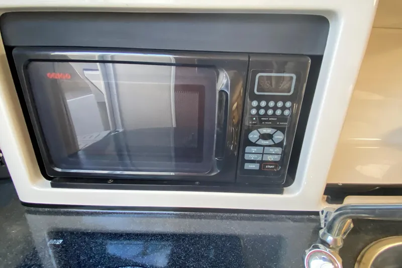 Slide: The Image of Microwave in 2004 Monterey 245 Cruiser boat kitchen area. - 31