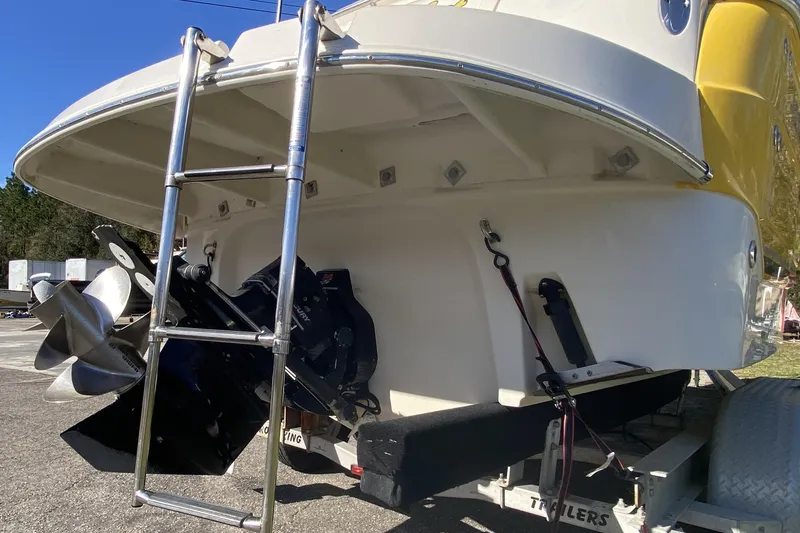 Slide: The Image of 2004 Monterey 245 Cruiser boat stern with ladder and propeller on trailer. - 6