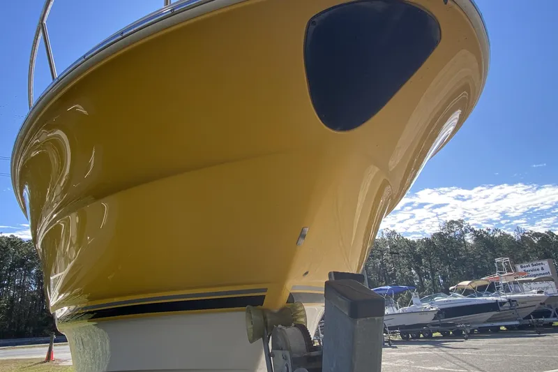 Slide: The Image of Yellow 2004 Monterey 245 Cruiser boat on trailer under clear blue sky. - 7