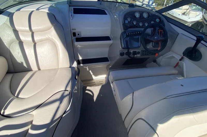 Slide: The Image of 2004 Monterey 245 Cruiser interior with steering wheel, gauges, and beige seating. - 9