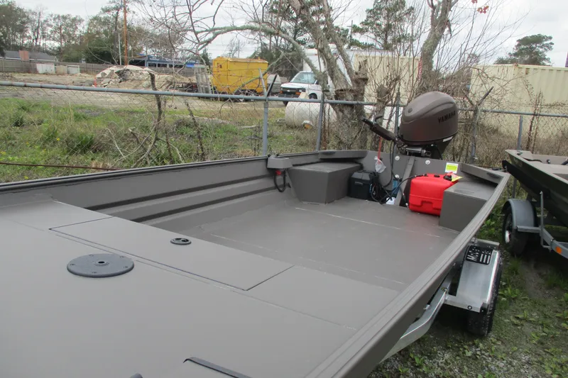 Slide: The Image of 2026 Alweld 1756 Marsh boat with Yamaha motor, parked outdoors. - 1