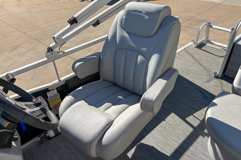Slide: The Image of Captain's chair on 2021 Bennington 188 SV pontoon boat, featuring plush gray upholstery. - 11