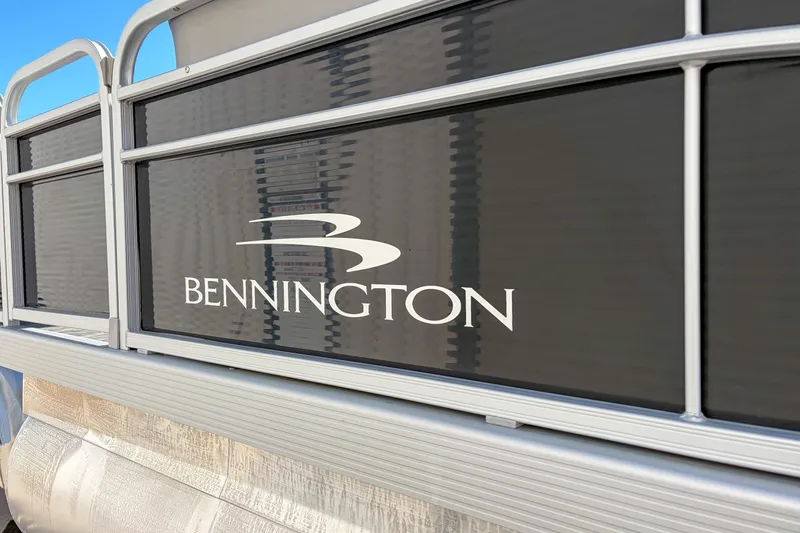 Slide: The Image of 2021 Bennington 188 SV pontoon boat with sleek black paneling and logo. - 5