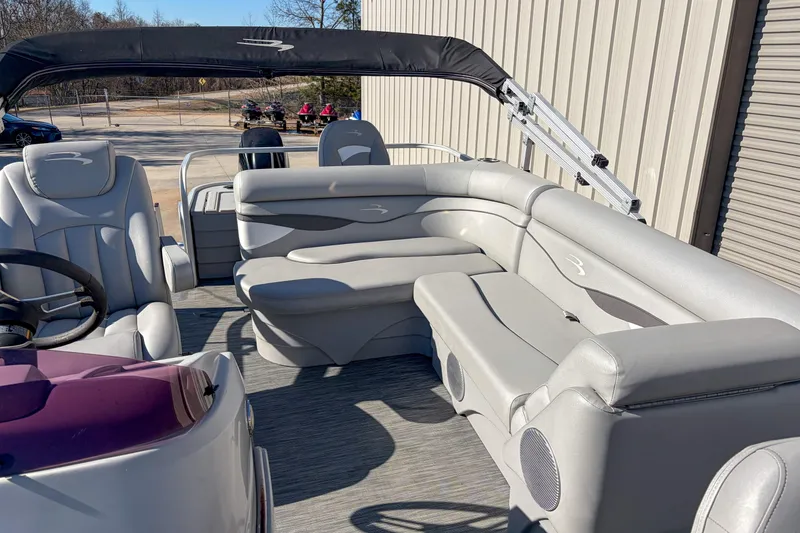 Slide: The Image of 2021 Bennington 188 SV pontoon boat interior with gray seating and steering wheel. - 9