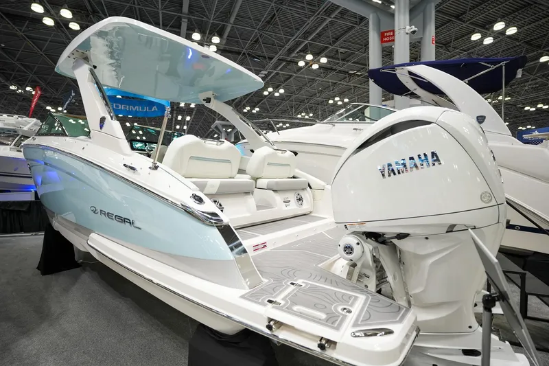 The Image of 2026 Regal LX9 boat with Yamaha engine displayed at an indoor boat show. - 0