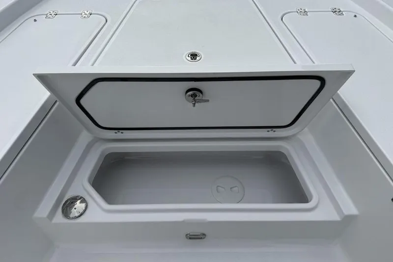 Slide: The Image of Storage compartment on 2026 Sportsman Masters 227 Bay Boat, featuring secure latch and spacious interior. - 12
