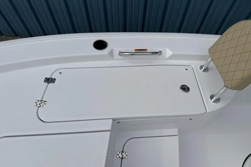 Slide: The Image of 2026 Sportsman Masters 227 Bay Boat deck with storage hatch and cushioned seat. - 16