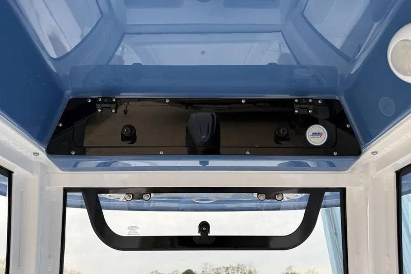 Slide: The Image of Interior view of 2026 Sportsman Masters 227 Bay Boat's helm station with blue accents. - 19