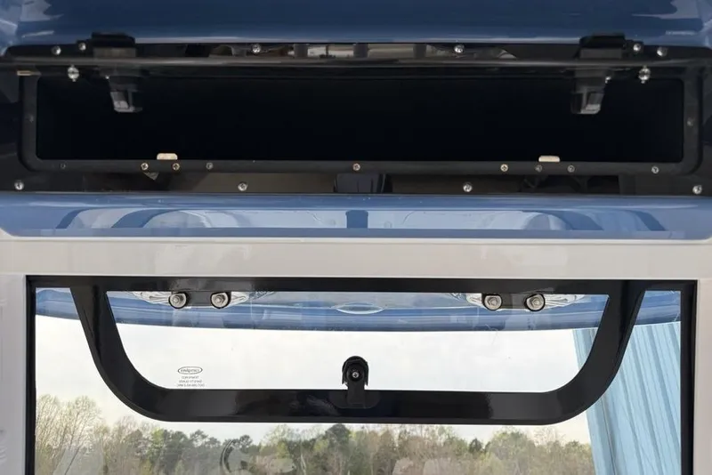 Slide: The Image of 2026 Sportsman Masters 227 Bay Boat storage compartment with open hatch, showcasing interior details. - 22